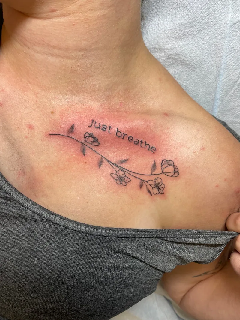 Quote and flowers on collarbone