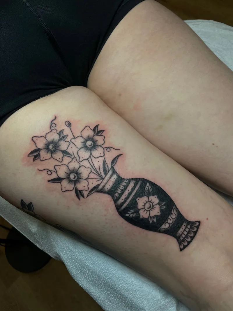B&G flowers in a vase tattoo by Jesse